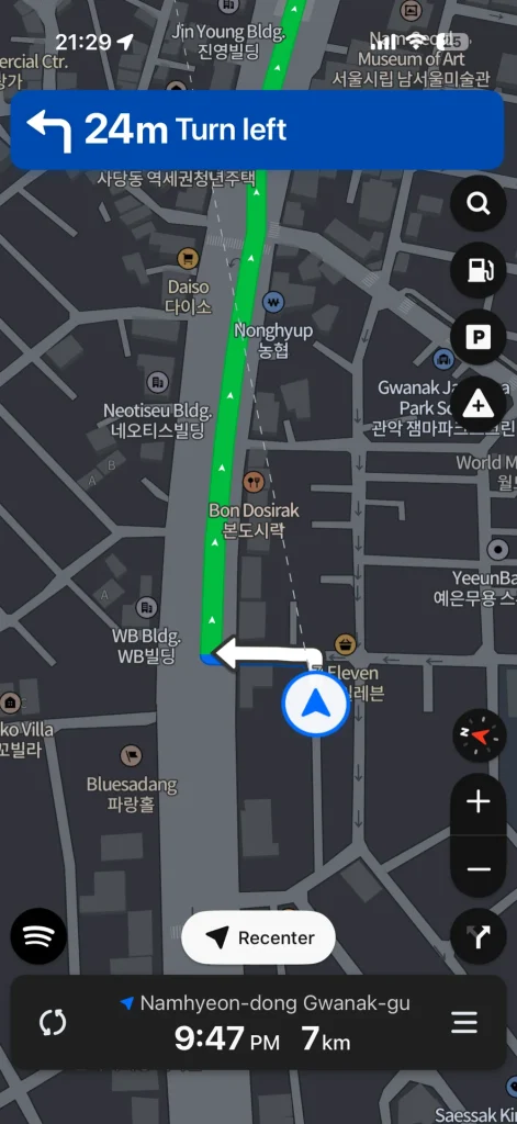 NAVER Map driving navigation in English showing a Turn left instruction and an English destination bar